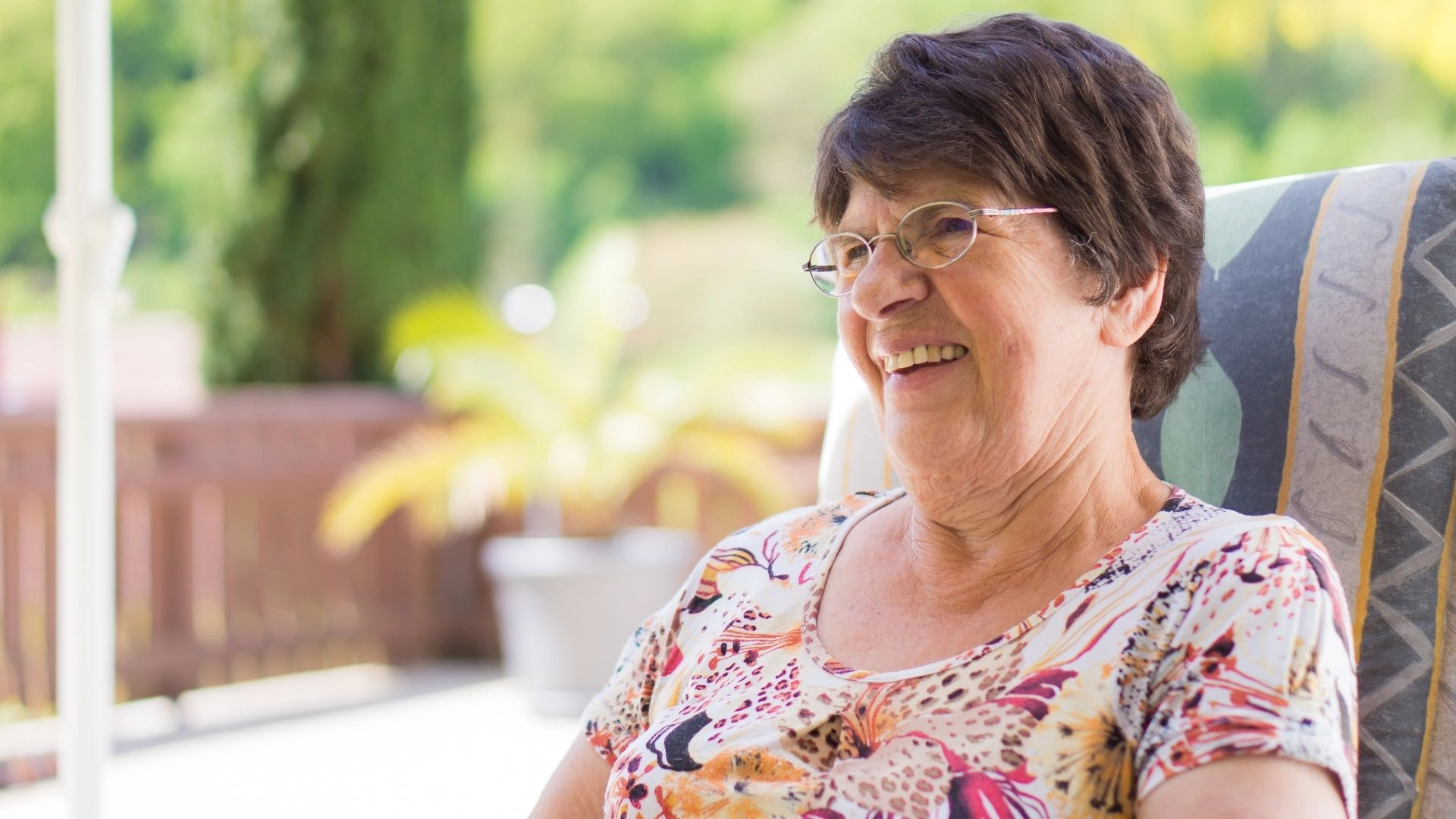 Senior woman enjoying fresh air and relaxation on the patio
