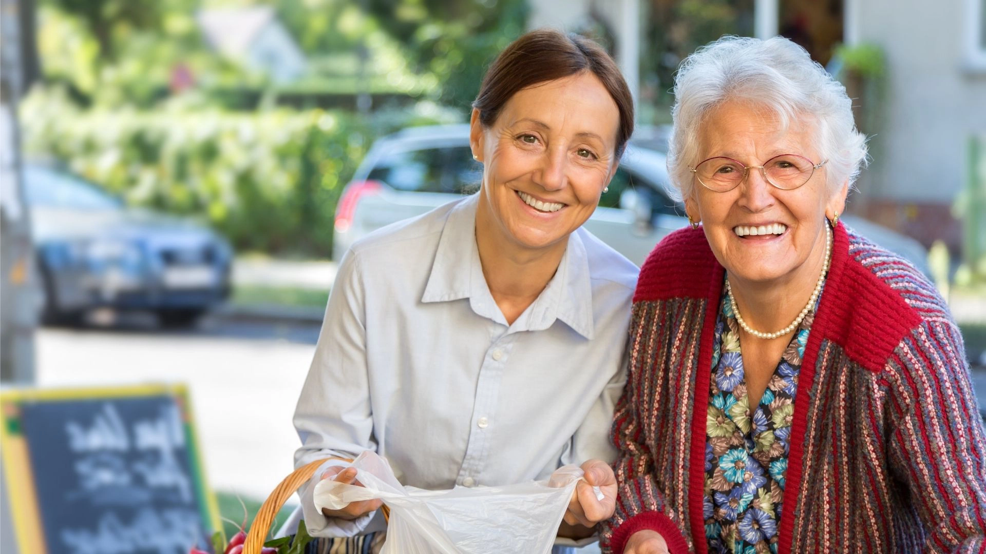 Caregiver assisting a senior woman with grocery shopping