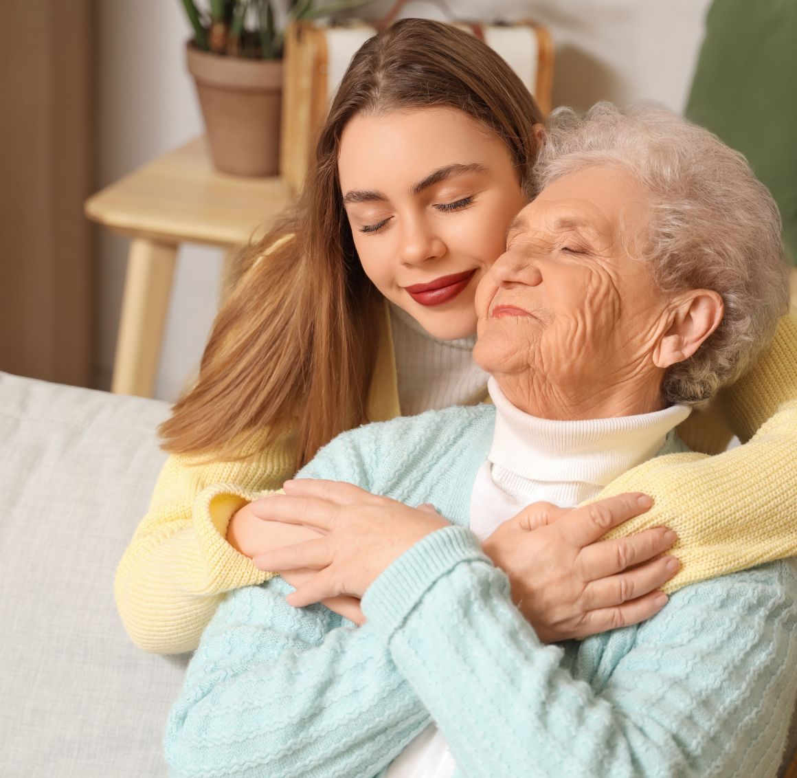 A caregiver gently hugging an elderly woman, providing emotional support and companionship as part of home care in Calipatria.