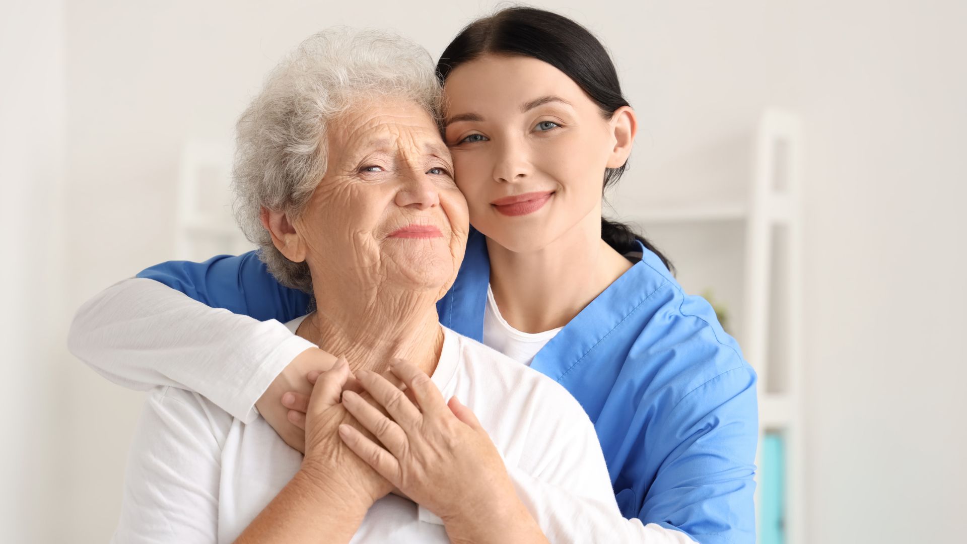 Caregiver providing compassionate home care in Westmorland, CA while supporting an elderly woman at home