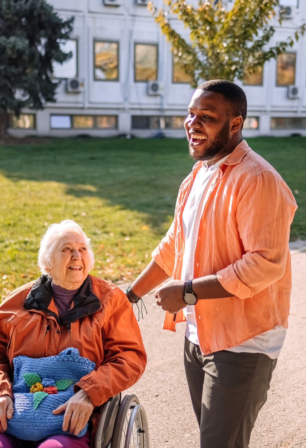 Caregiver assisting a senior woman in a wheelchair outdoors, reflecting Home Care in Burbank, CA